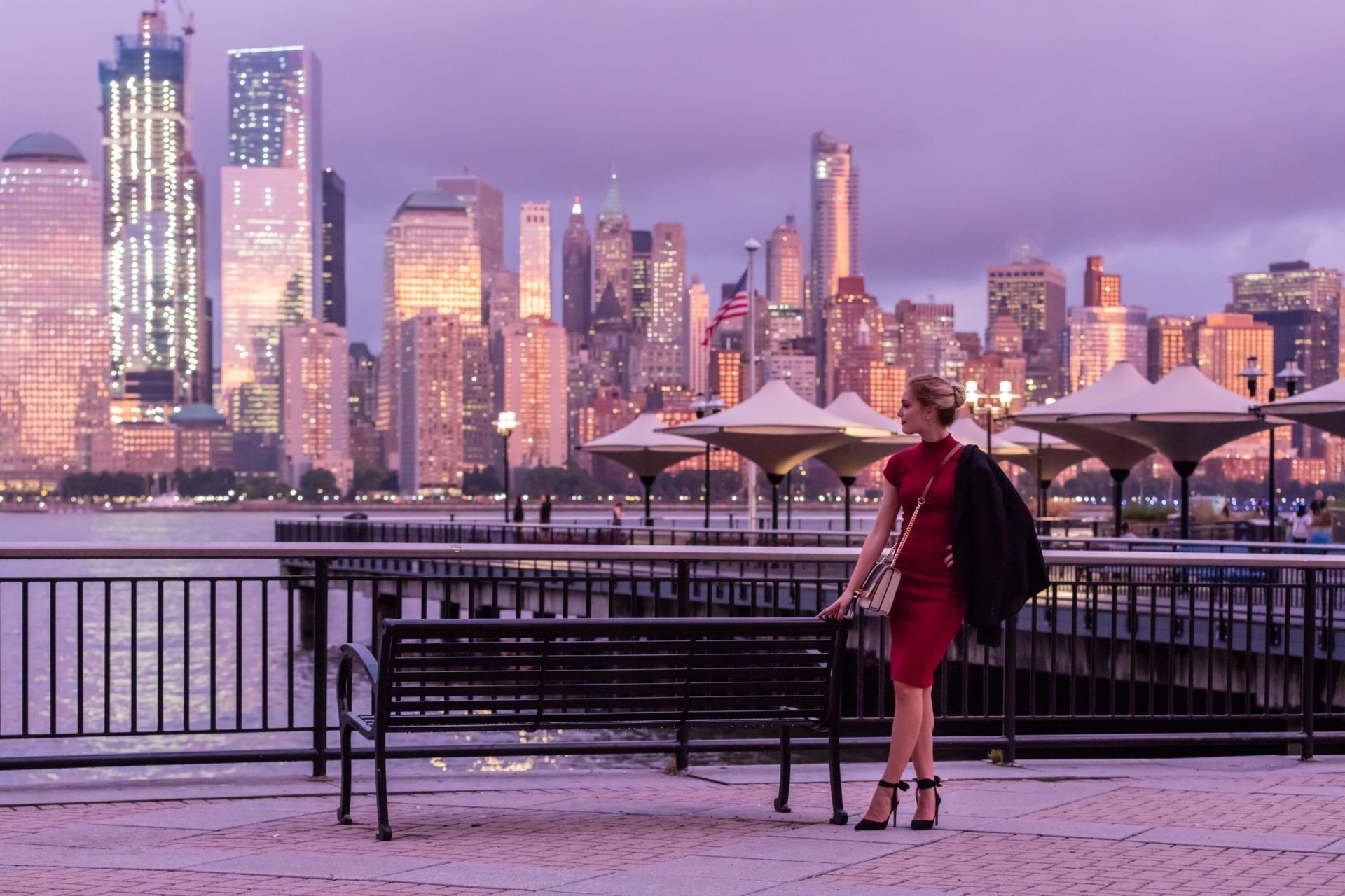 woman in red dress at exchange place jersey city pier