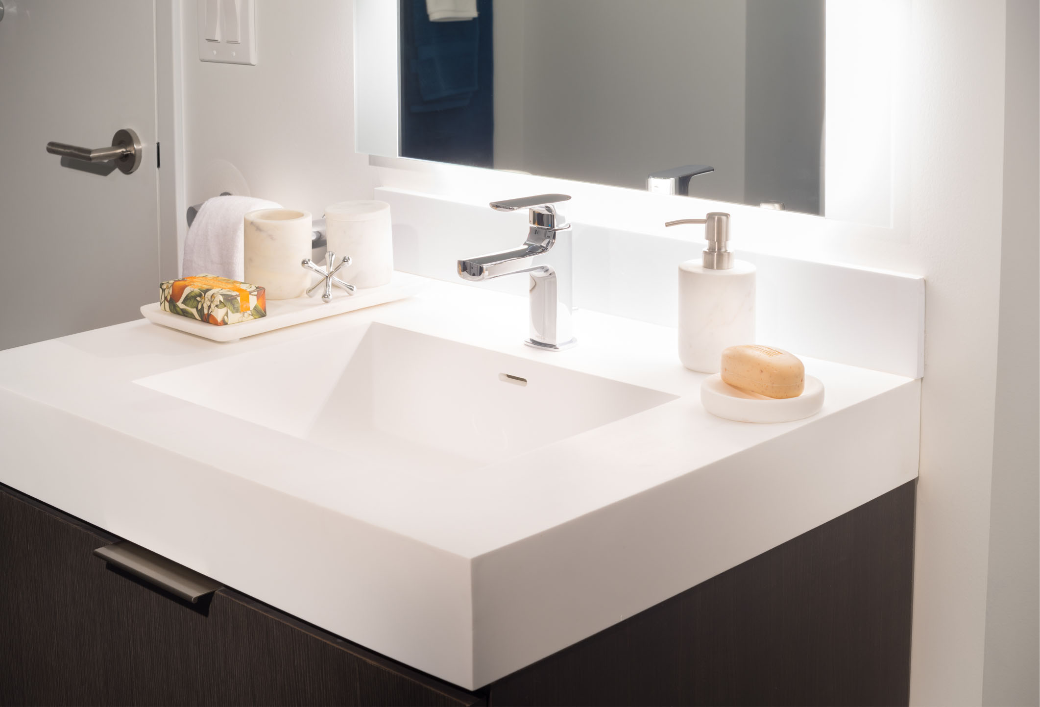 white bathroom vanity with frown cabinet and clean finishes