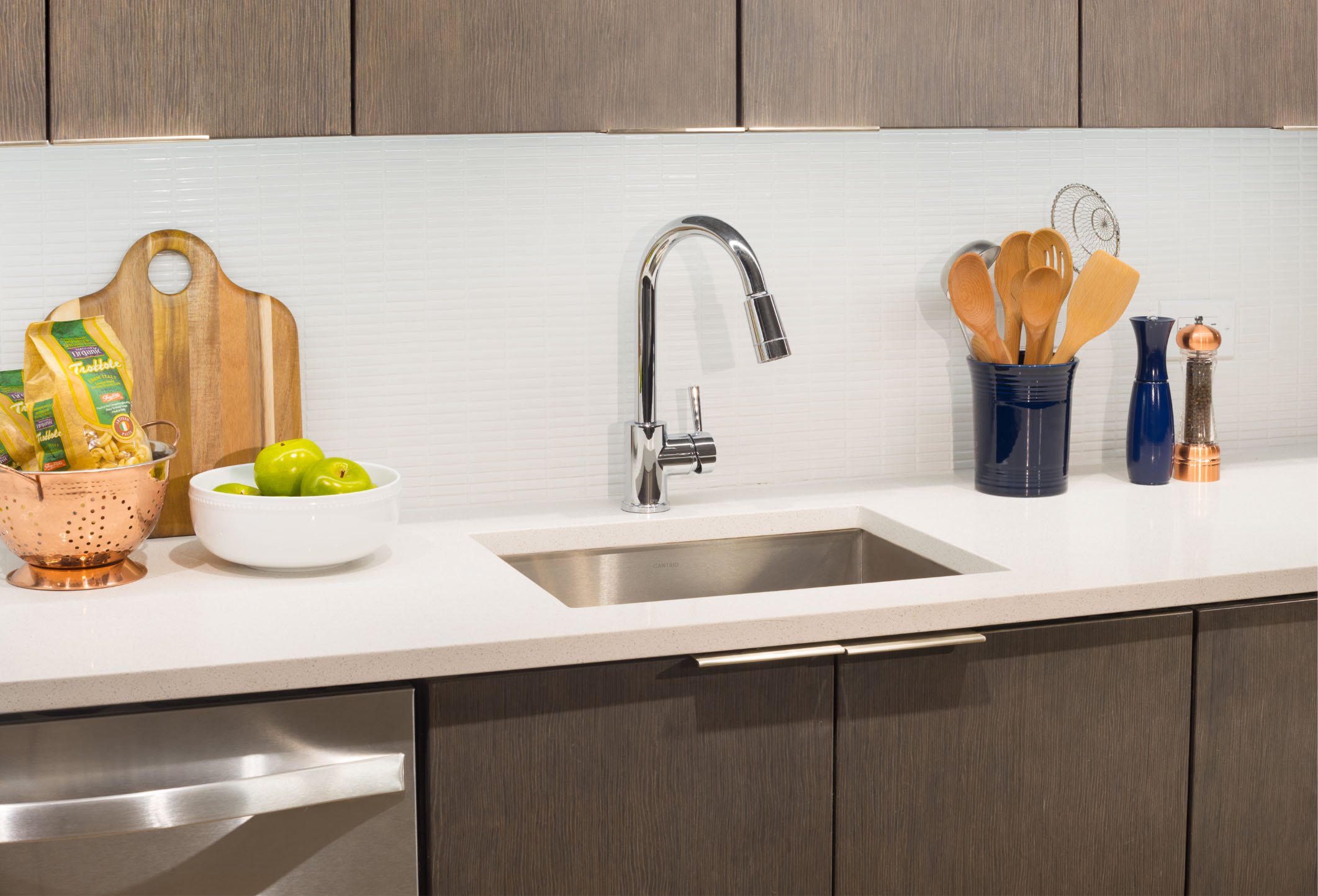 wood finishes and deep kitchen sink with white counters