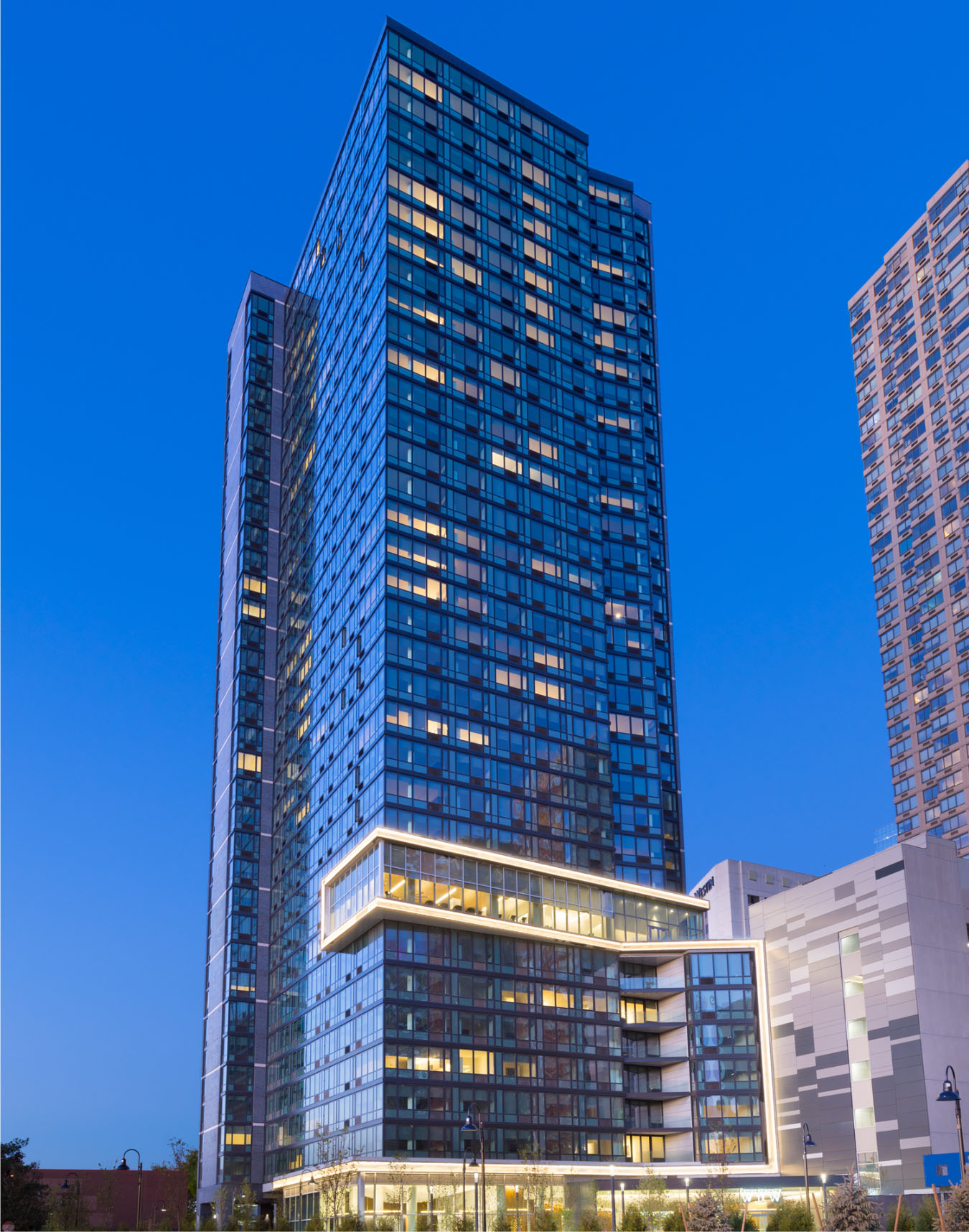 night photo of vyv apartments in newport jersey city