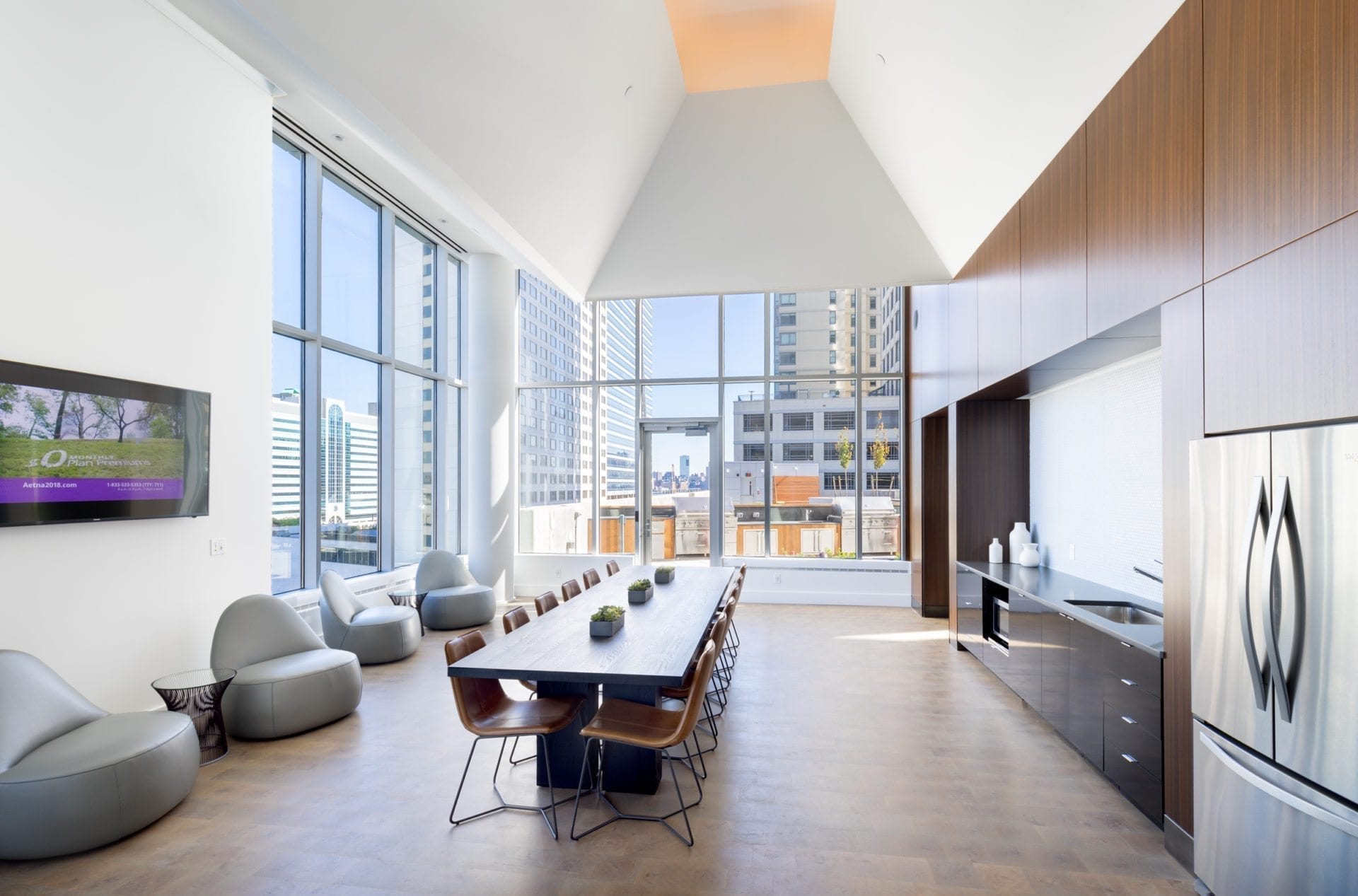 meeting dining room with long table and large wall of windws